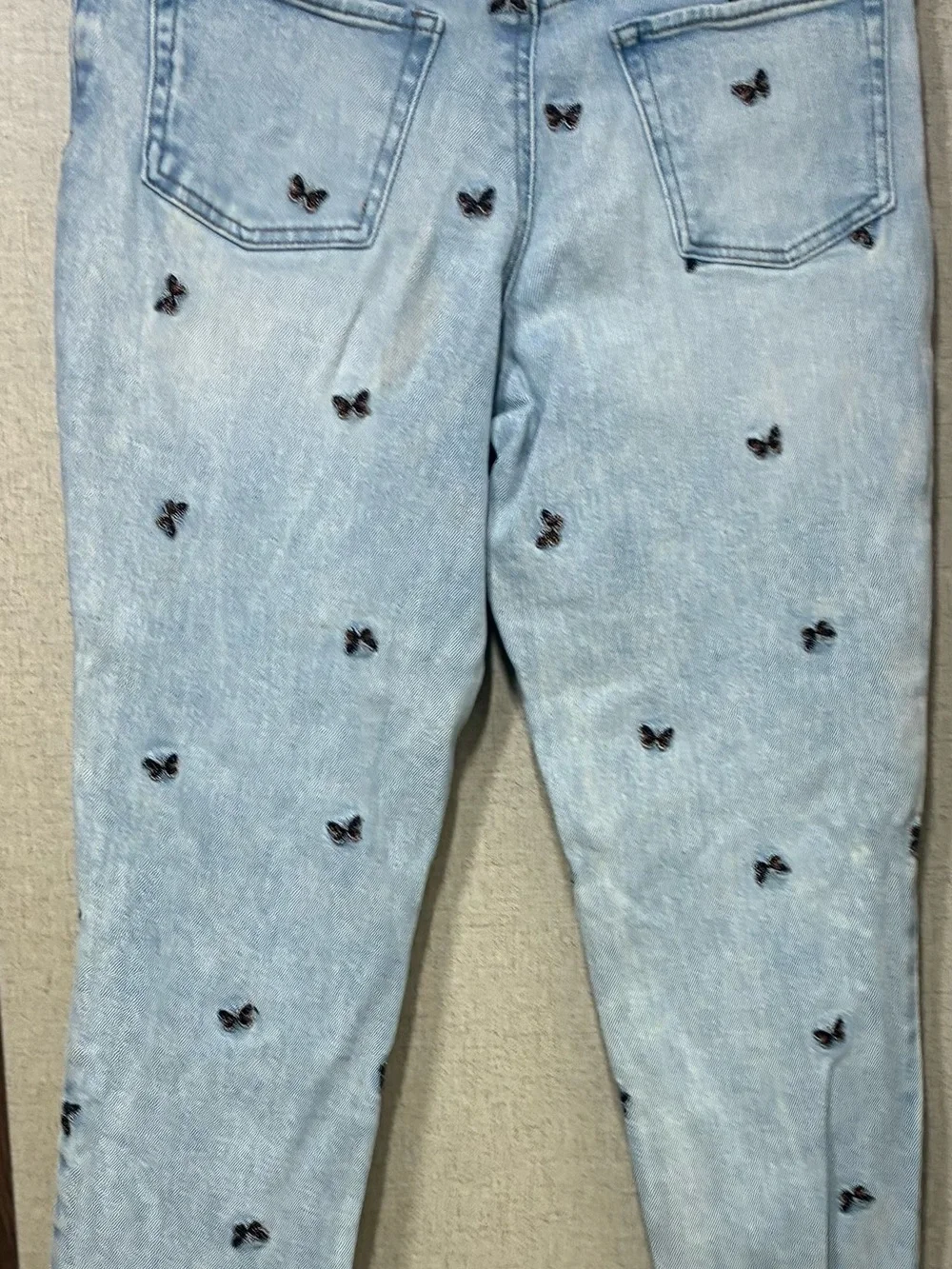 Tinseltown Light Blue Skinny Jeans with Black Butterfly Embroidery and Knee Rips